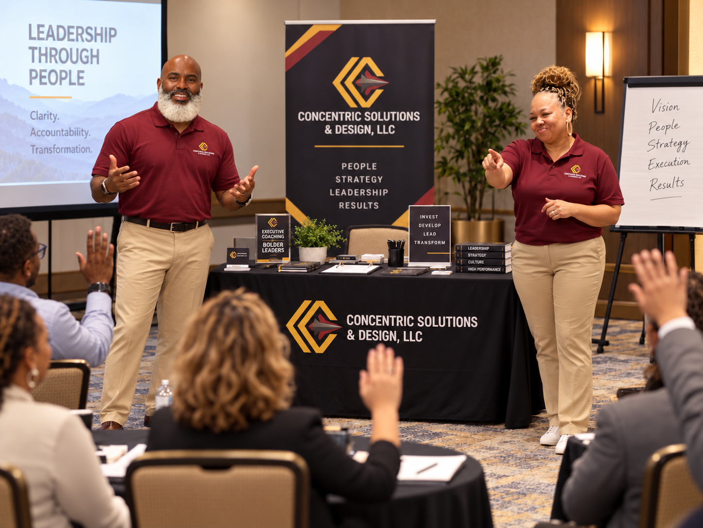 Two coaches leading a leadership workshop with an audience